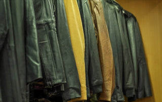 Leather jackets hanging neatly in a closet for proper maintenance.