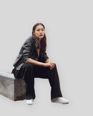 Woman seated wearing Raven Black Quilted Biker Leather Jacket