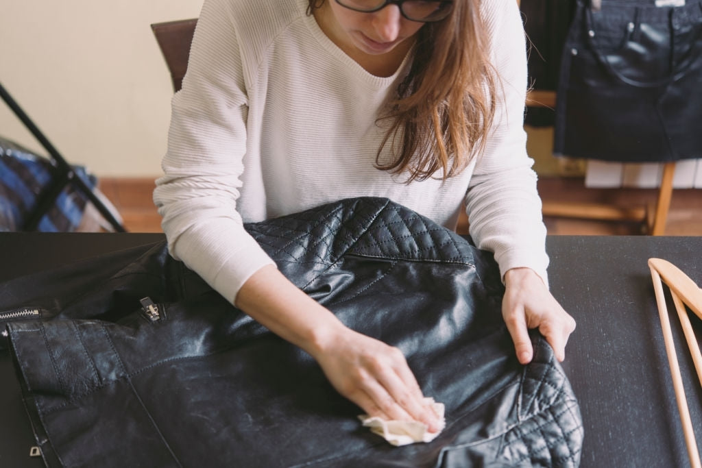 women cleaning leather jacket