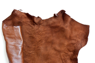 Rich brown calfskin leather showcasing smooth and textured surfaces.