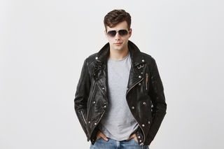 Stylish man in black leather jacket and sunglasses for casual day out