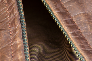 Close-up of leather jacket lining and zipper detail.