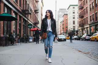 Woman wearing a casual black leather jacket with jeans and a white t-shirt for an everyday styled look