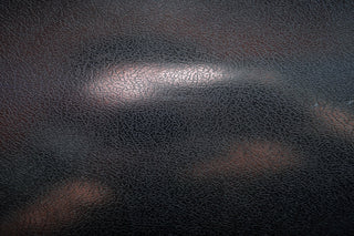 Close-up texture of genuine leather surface with natural grain pattern