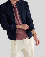 Model wearing Baris dark blue suede bomber jacket